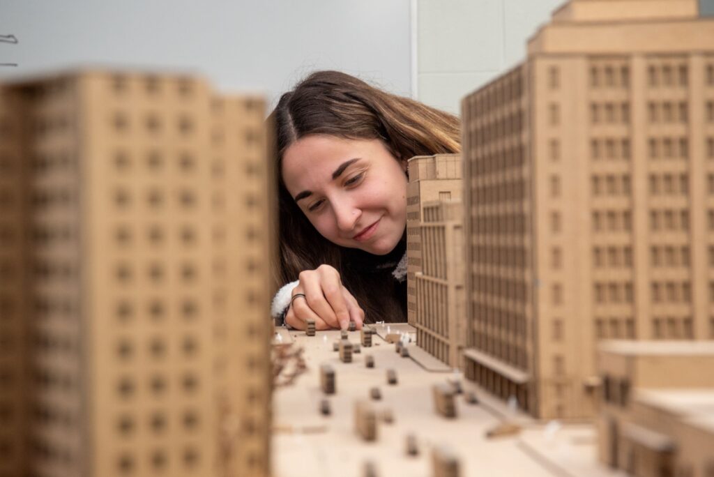 A female student creates a three-dimensional model out of cardboard for an architectural drafting training class at a Western New York Works college.