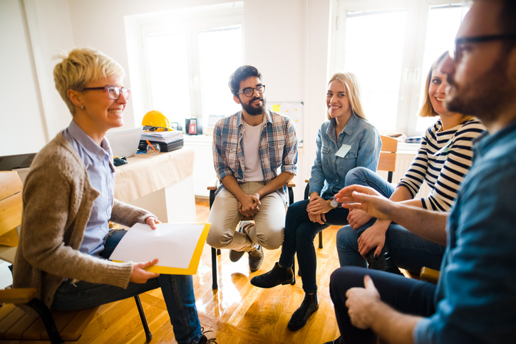 A CASAC worker meets with a group of four students at a Western New York Works college.