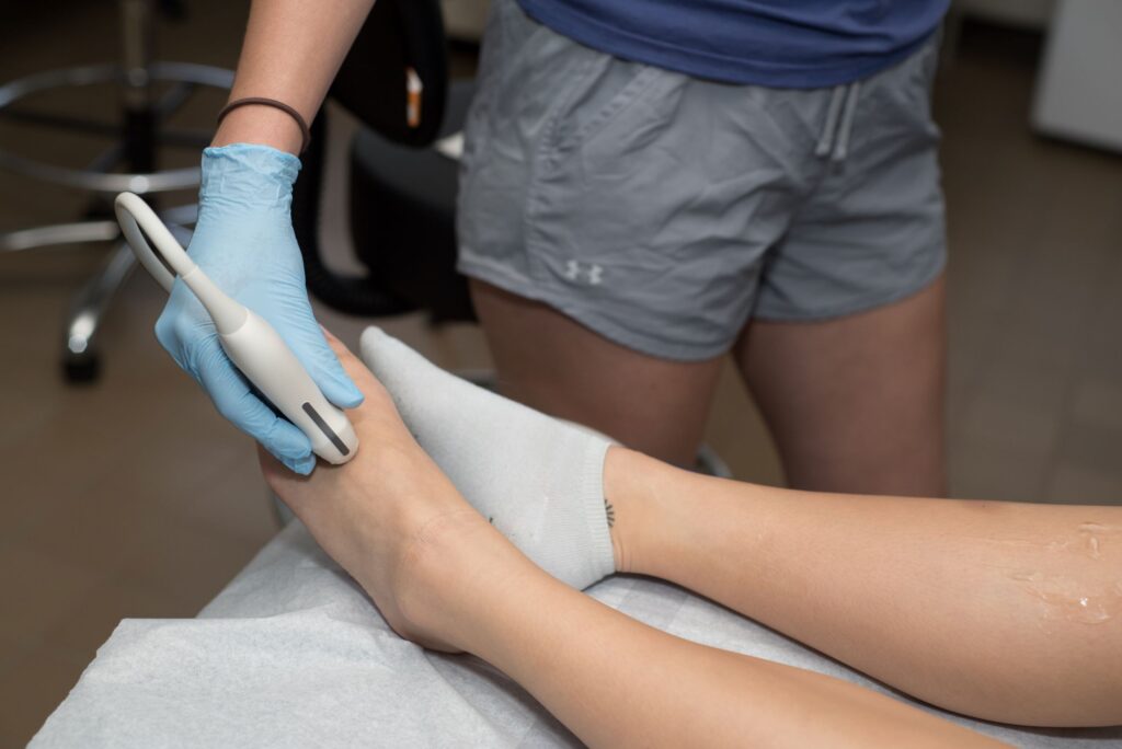 A sonography student practices using ultrasound equipment in a training space at a Western New York Works college