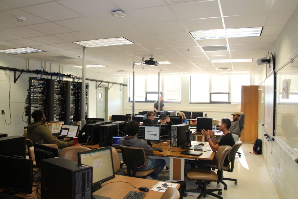 A group of computer network technician students practice configuring networks in a lab environment at a Western New York Works college.