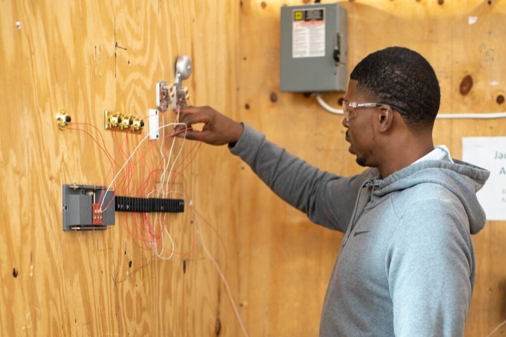 A student gets experience operating equipment typically used by electronics professionals in a career training program at a Western New York Works college.